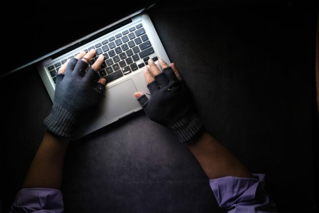 person in black long sleeve shirt using macbook pro